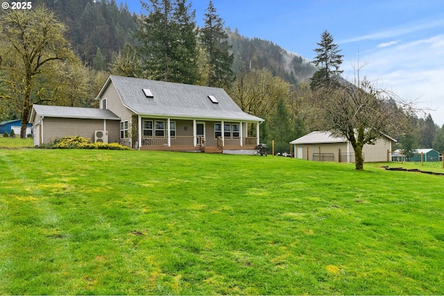 40510 NE 261st Ct, Amboy, WA 98601 - rear view of house with a detached garage, a lawn, and covered porch