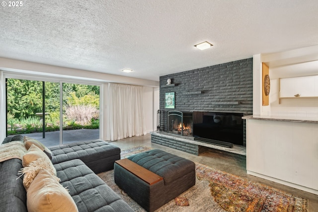 living room with finished concrete floors, a textured ceiling, and a brick fireplace