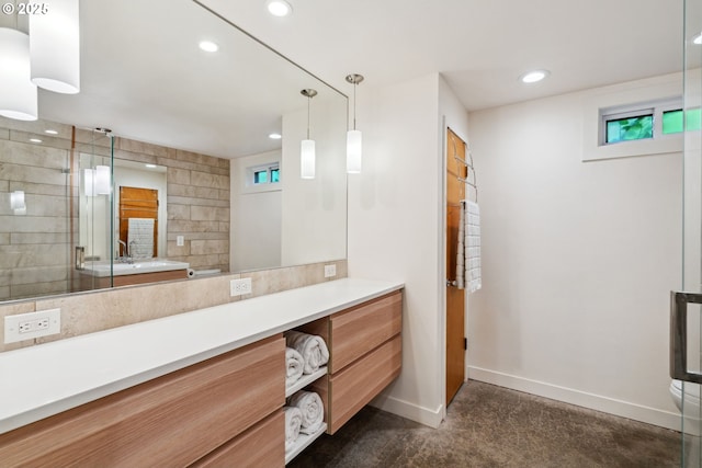 bathroom featuring baseboards, recessed lighting, a shower with door, and vanity