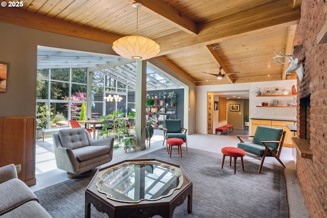 carpeted living room featuring wood ceiling, a brick fireplace, and beam ceiling