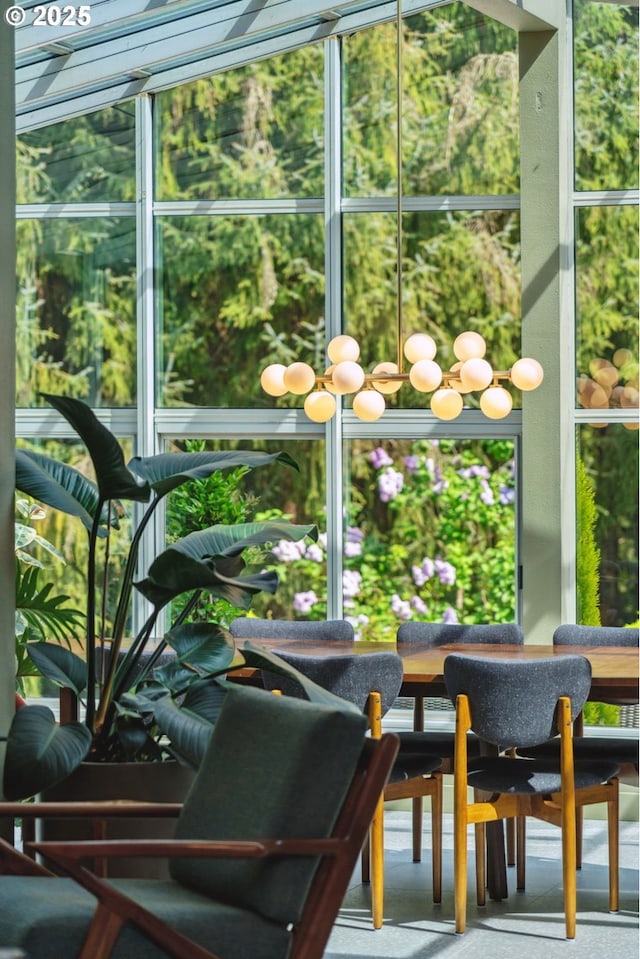 sunroom featuring an inviting chandelier