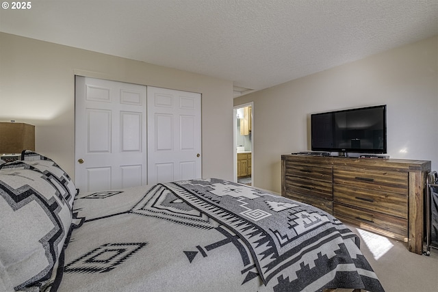 bedroom with carpet floors, a textured ceiling, and a closet