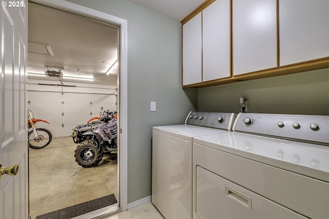 laundry area featuring cabinets and washing machine and clothes dryer