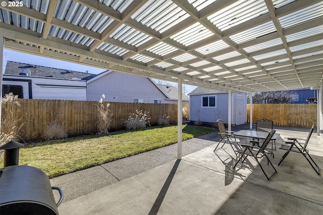 view of patio / terrace with a storage unit and a pergola