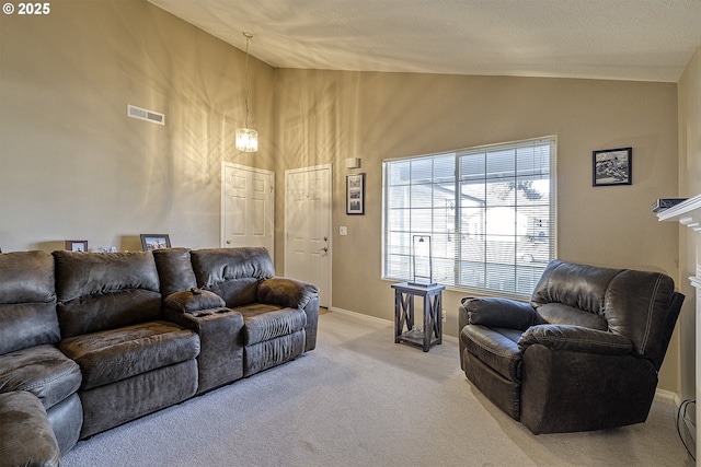 living room with high vaulted ceiling and carpet flooring