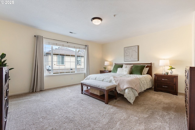 carpeted bedroom featuring baseboards and visible vents