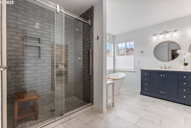 full bath with a freestanding bath, vanity, a shower stall, and tile patterned flooring