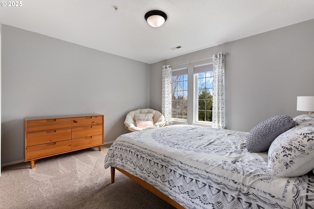 bedroom featuring light colored carpet, baseboards, and visible vents