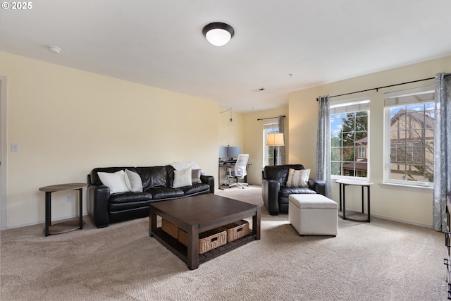 living area with light colored carpet and baseboards