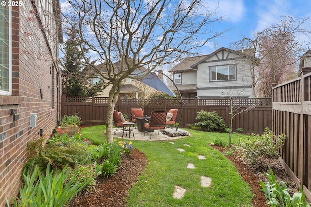 view of yard with a fenced backyard and a patio