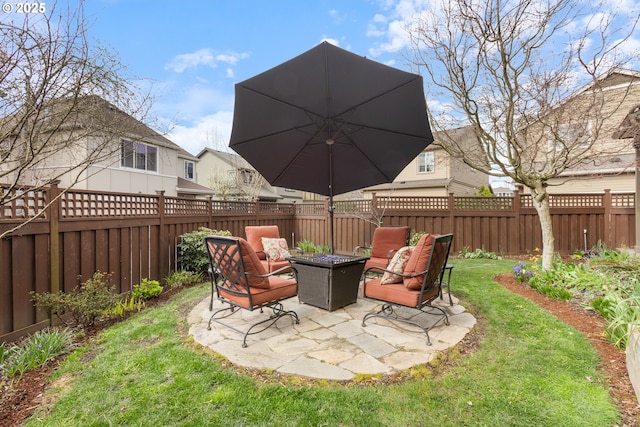 view of yard featuring a fenced backyard, an outdoor fire pit, and a patio
