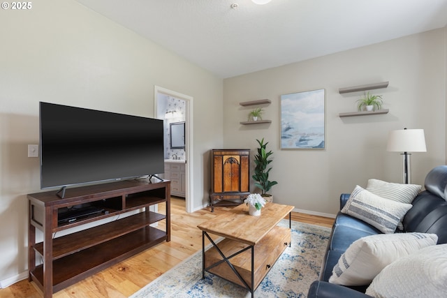 living room with light wood finished floors and baseboards