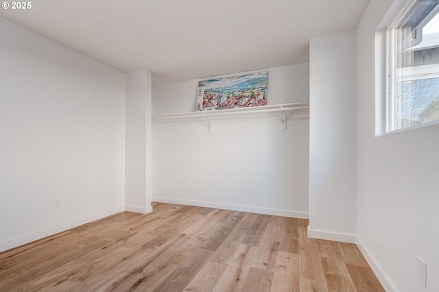 unfurnished bedroom with light wood-style floors and baseboards