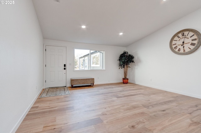 foyer featuring light wood finished floors, baseboards, and recessed lighting