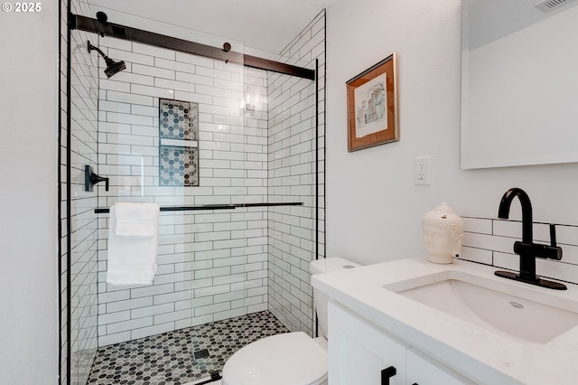 full bathroom featuring a stall shower, visible vents, vanity, and toilet