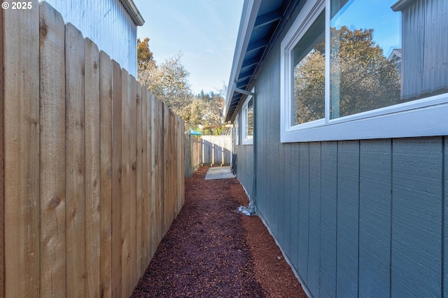 view of side of home with fence