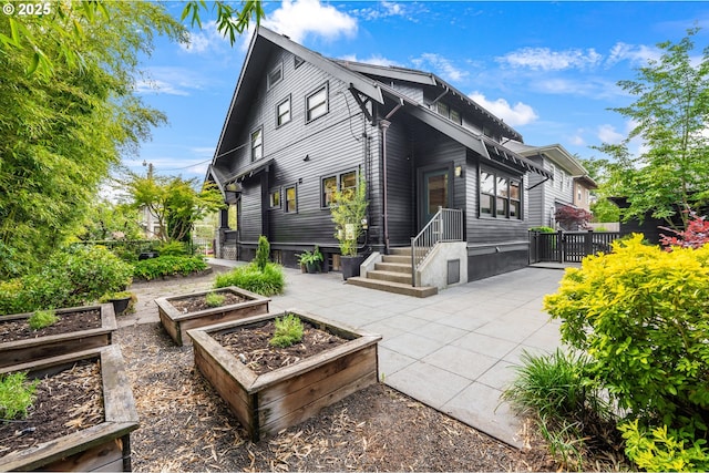 2225 NE 22nd Ave, Portland, OR 97212 - rear view of house with a vegetable garden
