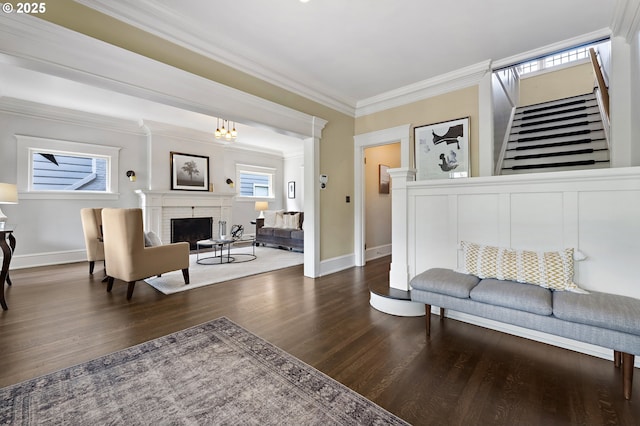 2225 NE 22nd Ave, Portland, OR 97212 - living area featuring a brick fireplace, stairs, crown molding, and wood finished floors