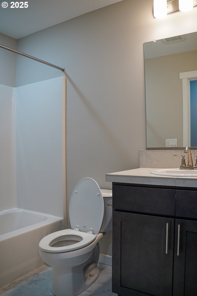 full bath with visible vents, toilet,  shower combination, marble finish floor, and vanity