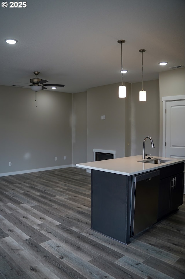 kitchen with a sink, dark wood-type flooring, dishwasher, and an island with sink