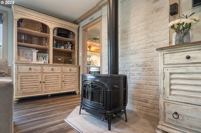 128 NW 20th Ave, Rockaway Beach, OR 97136 - detailed view of a wood stove, wood finished floors, and crown molding