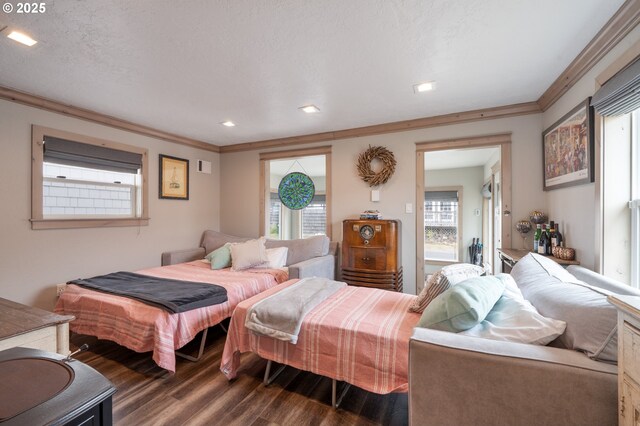 128 NW 20th Ave, Rockaway Beach, OR 97136 - bedroom with dark wood-style flooring, ornamental molding, and recessed lighting