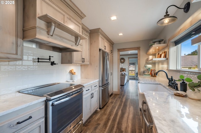 128 NW 20th Ave, Rockaway Beach, OR 97136 - kitchen featuring appliances with stainless steel finishes, dark wood-style floors, tasteful backsplash, and light stone counters