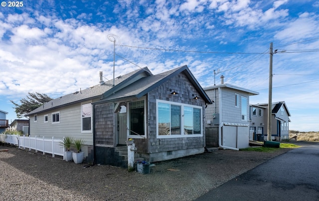 128 NW 20th Ave, Rockaway Beach, OR 97136 - view of front of home featuring fence and entry steps