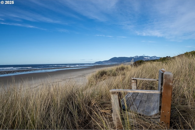128 NW 20th Ave, Rockaway Beach, OR 97136 - water view featuring nearby beach and a mountainous background