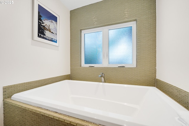 bathroom featuring tiled bath