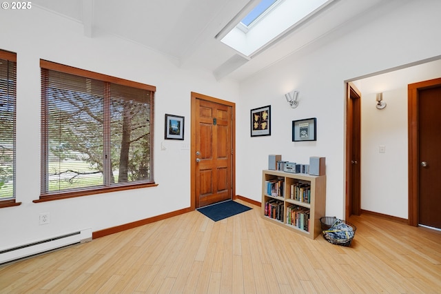 foyer entrance with a baseboard heating unit, baseboards, beam ceiling, a skylight, and wood finished floors