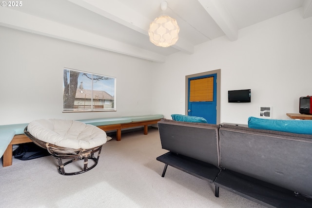 living area with beam ceiling and carpet flooring