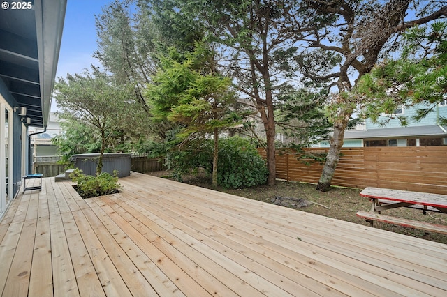 wooden terrace featuring a fenced backyard