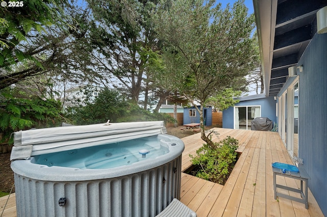 deck featuring area for grilling and a hot tub