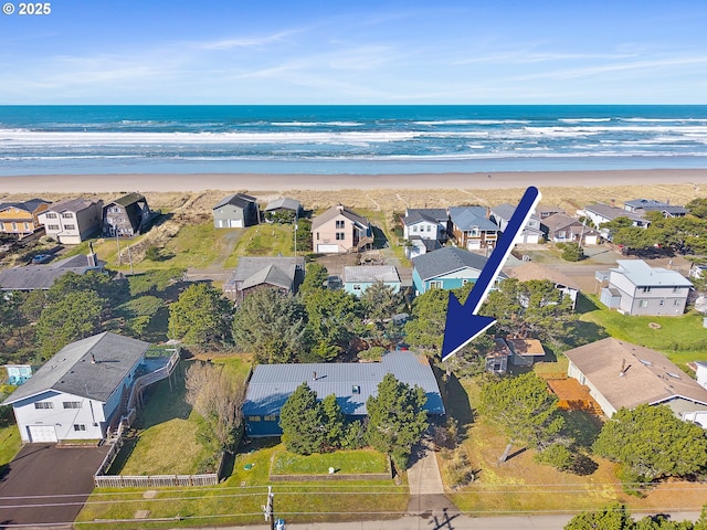 drone / aerial view with a view of the beach, a residential view, and a water view