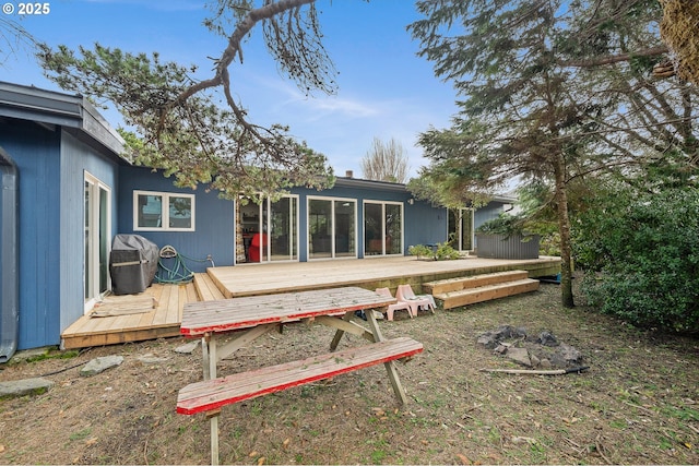 rear view of house featuring a deck