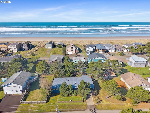 aerial view featuring a beach view, a residential view, and a water view