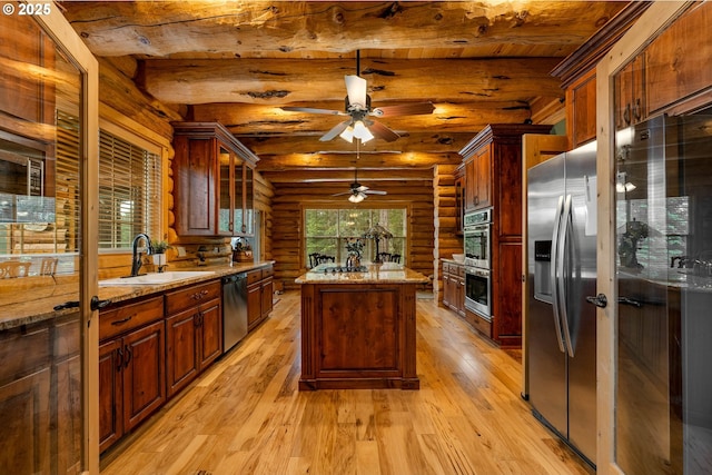 400 Rockinghorse Dr, Grants Pass, OR 97527 - kitchen with rustic walls, a sink, stainless steel appliances, light wood-style floors, and beamed ceiling