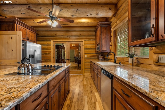 400 Rockinghorse Dr, Grants Pass, OR 97527 - kitchen featuring appliances with stainless steel finishes, a sink, light wood-type flooring, beam ceiling, and light stone counters