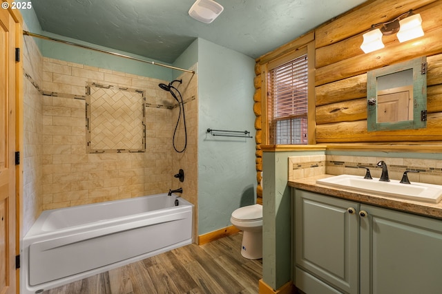 400 Rockinghorse Dr, Grants Pass, OR 97527 - bathroom featuring wood finished floors, toilet, log walls, baseboards, and vanity