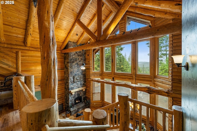 400 Rockinghorse Dr, Grants Pass, OR 97527 - living room with beamed ceiling, wood-type flooring, high vaulted ceiling, wood ceiling, and a stone fireplace