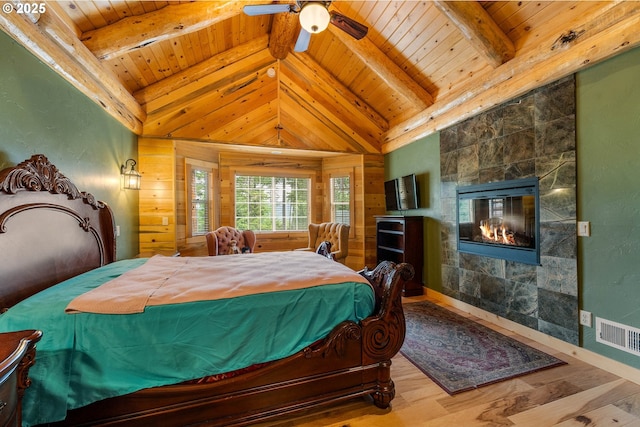 400 Rockinghorse Dr, Grants Pass, OR 97527 - bedroom with wooden ceiling, wood finished floors, wood walls, and a tile fireplace