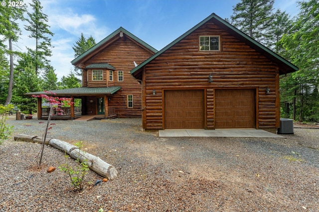 400 Rockinghorse Dr, Grants Pass, OR 97527 - view of front of house featuring central AC, a garage, gravel driveway, and covered porch