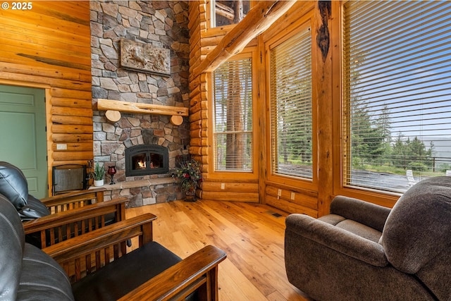 400 Rockinghorse Dr, Grants Pass, OR 97527 - living room featuring rustic walls, hardwood / wood-style flooring, and a stone fireplace