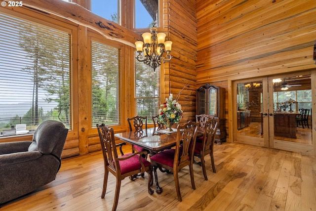 400 Rockinghorse Dr, Grants Pass, OR 97527 - dining space featuring french doors, a high ceiling, light wood-style floors, healthy amount of natural light, and a chandelier