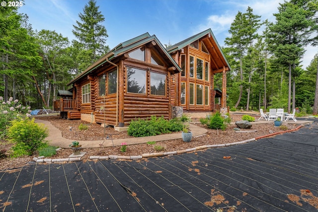 400 Rockinghorse Dr, Grants Pass, OR 97527 - view of home's exterior featuring log siding, a deck, and a patio area