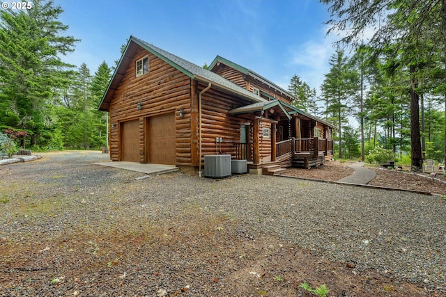 400 Rockinghorse Dr, Grants Pass, OR 97527 - view of side of home featuring driveway, covered porch, central AC unit, and an attached garage