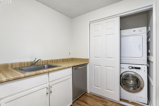 7124 SW Murray Blvd, Beaverton, OR 97008 - laundry area with estacked washer and dryer, dark wood-type flooring, and a textured ceiling