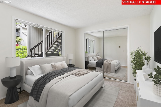 7124 SW Murray Blvd, Beaverton, OR 97008 - bedroom featuring carpet, a textured ceiling, and a closet