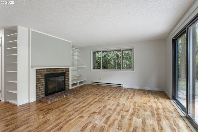 7124 SW Murray Blvd, Beaverton, OR 97008 - unfurnished living room featuring a baseboard radiator, a textured ceiling, built in shelves, wood finished floors, and baseboards